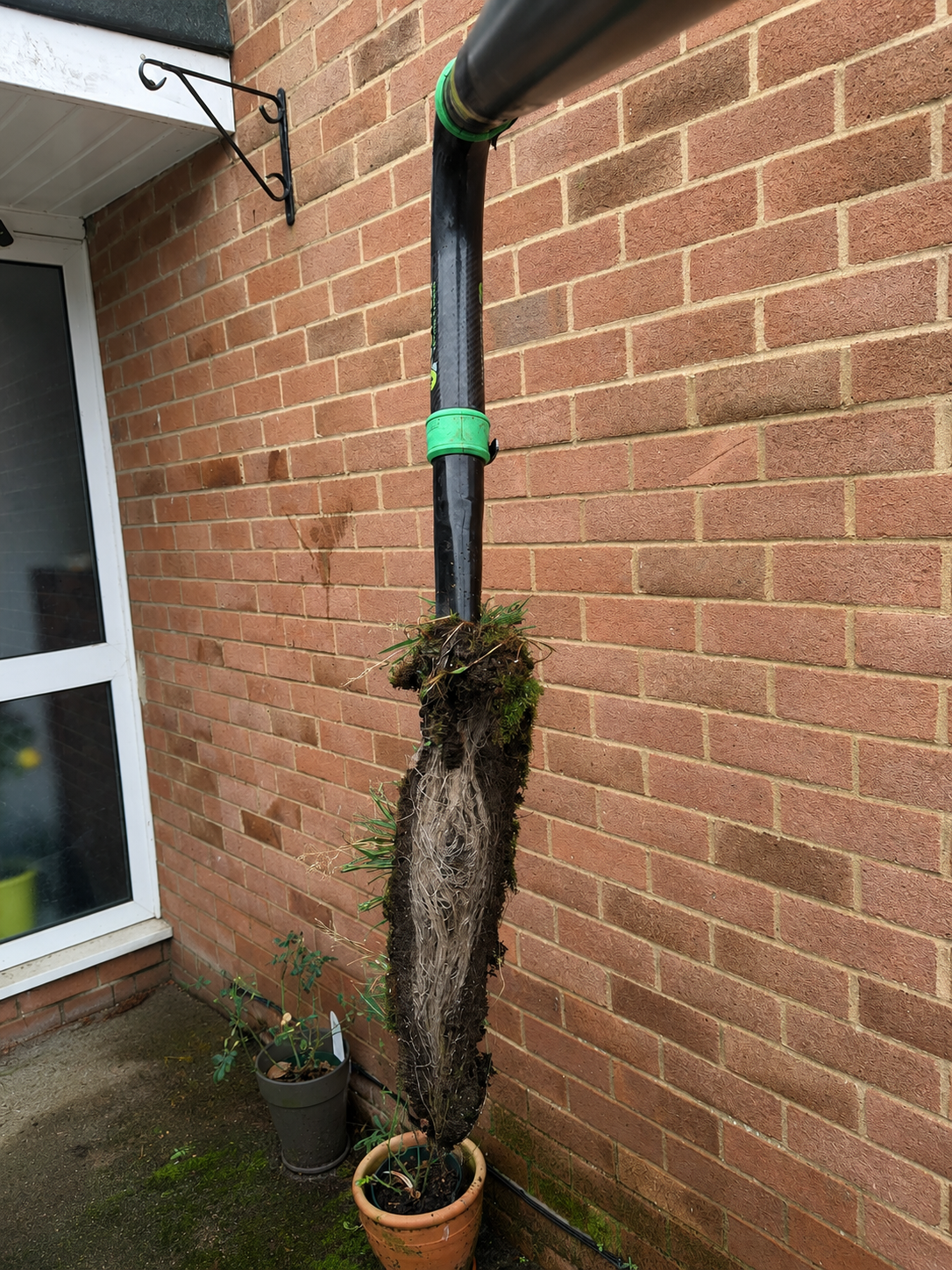 Large gutter blockage removed using professional gutter vacuum equipment